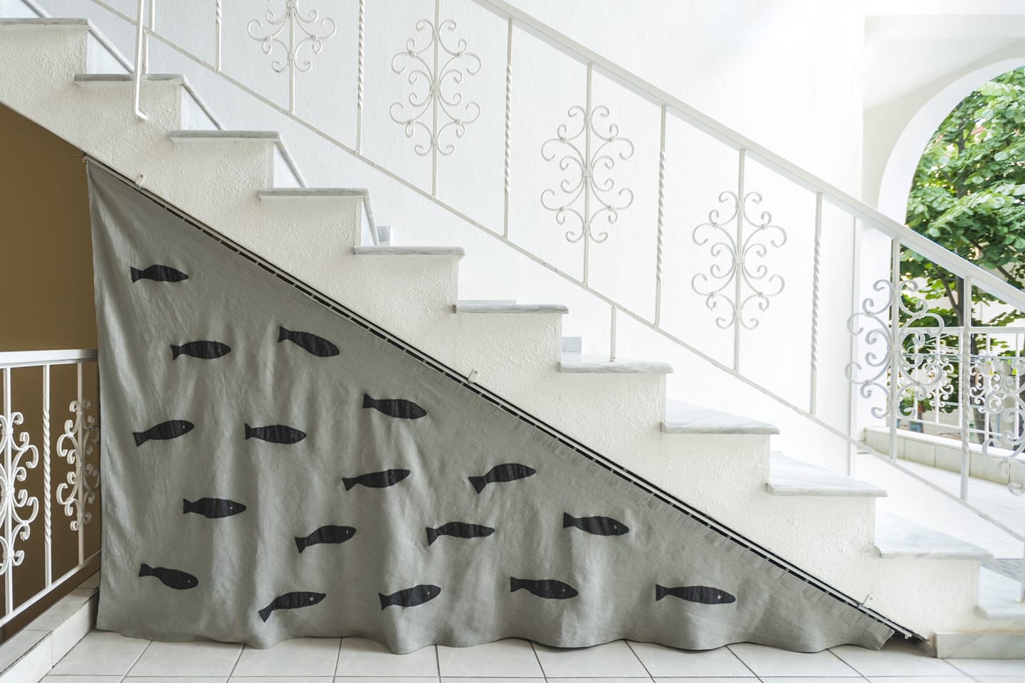 White staircase decorated with fish silhouettes